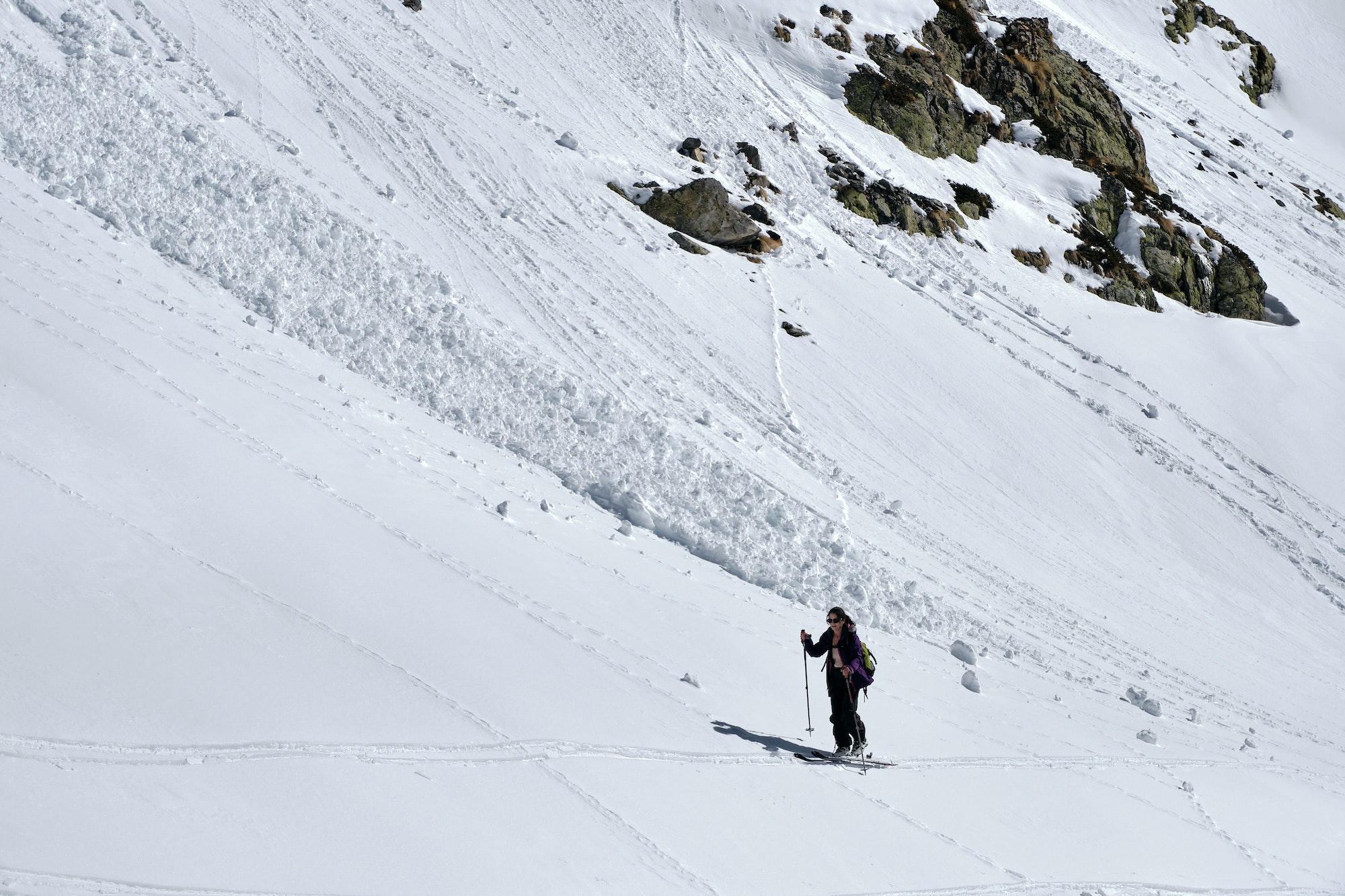Shot of a mountain covered in snow, people hiking in Col de la Lombarde Isola 2000 France