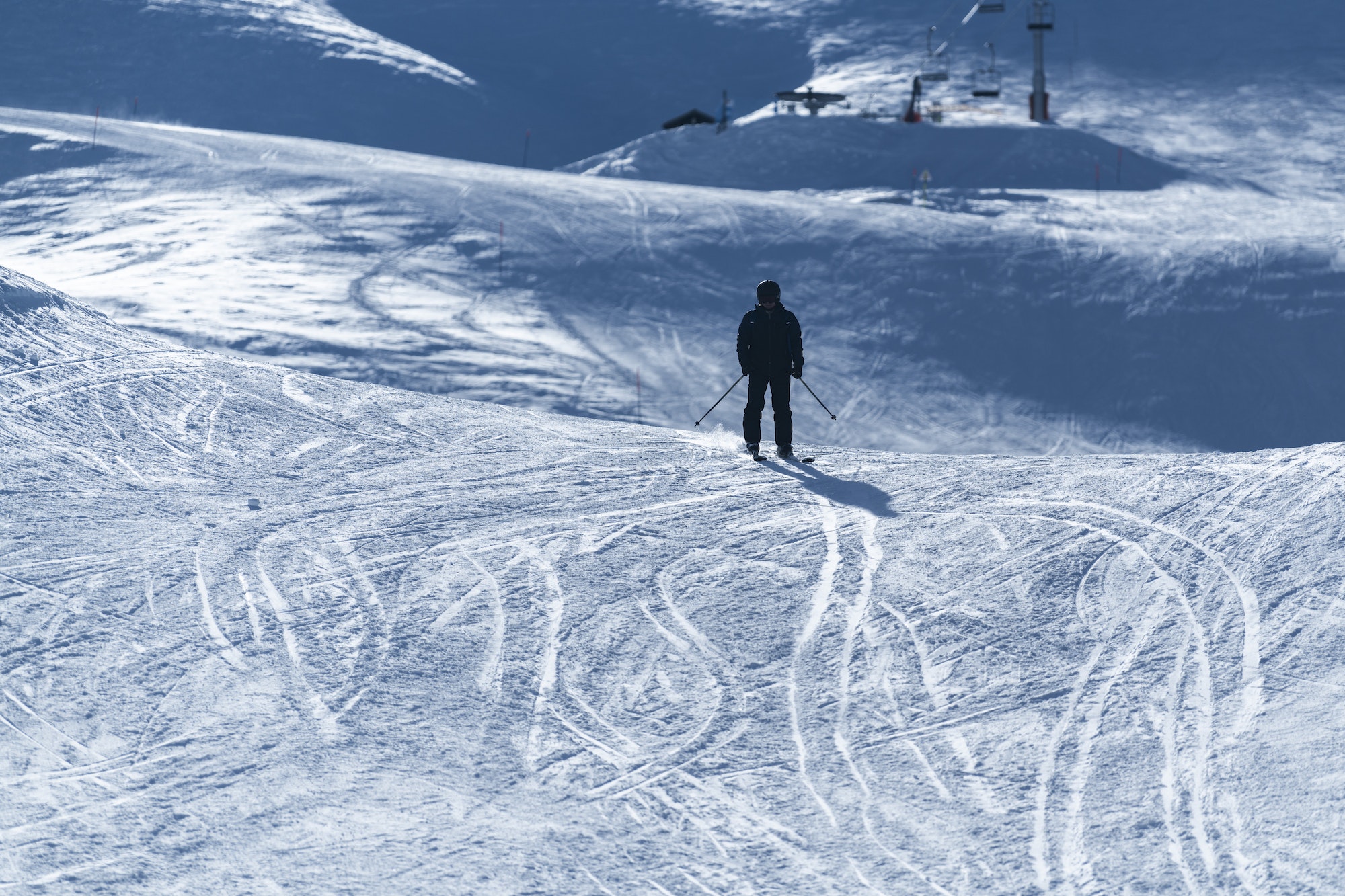 Skier skiing on ski slopes in the ski resort area of Avoriaz in the Alps Mountains, France, Europe