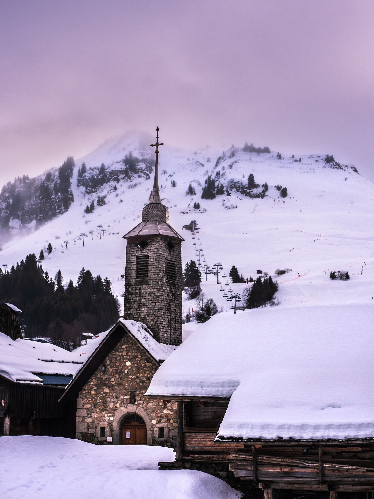 Vertical shot of the Chappelle du Chinaillon Chapel in Le Grand-Bornand, France in snowy winter