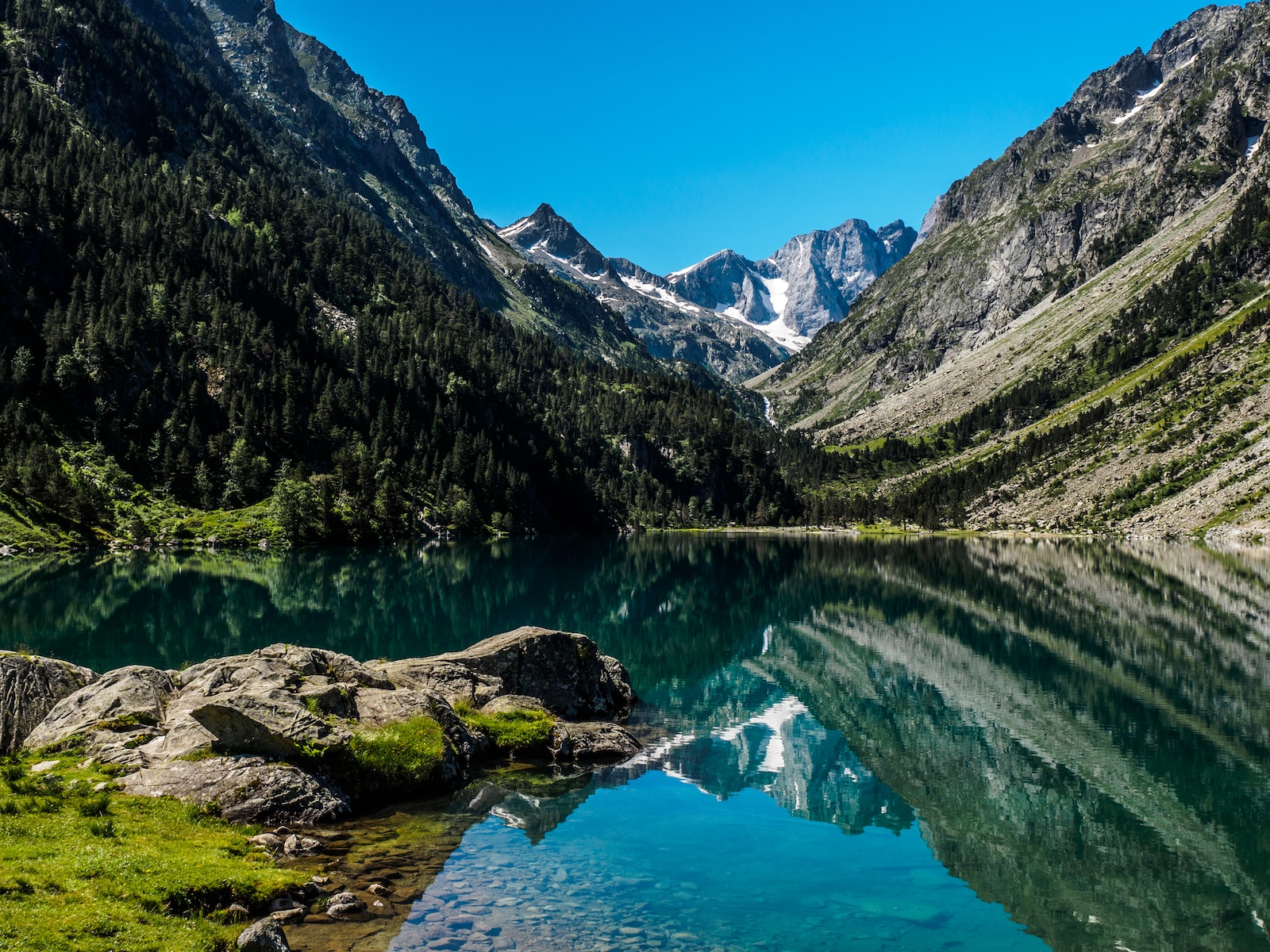 body of water beside mountain
